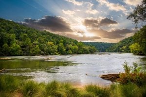 Sun shining through clouds over the west Chattahoochee River.