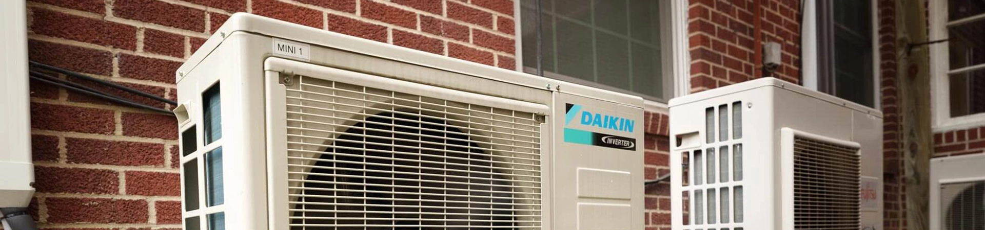 Daikin heat pump installed on the outside of a residential home.