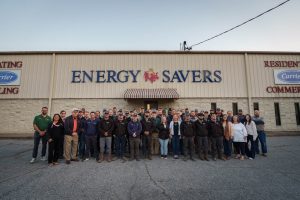 A group photo of the Energy Savers team in front of their office building in Columbus, GA.