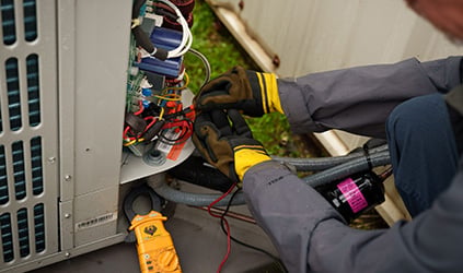 HVAC technician working on unit wiring HVAC technician working on unit wiring
